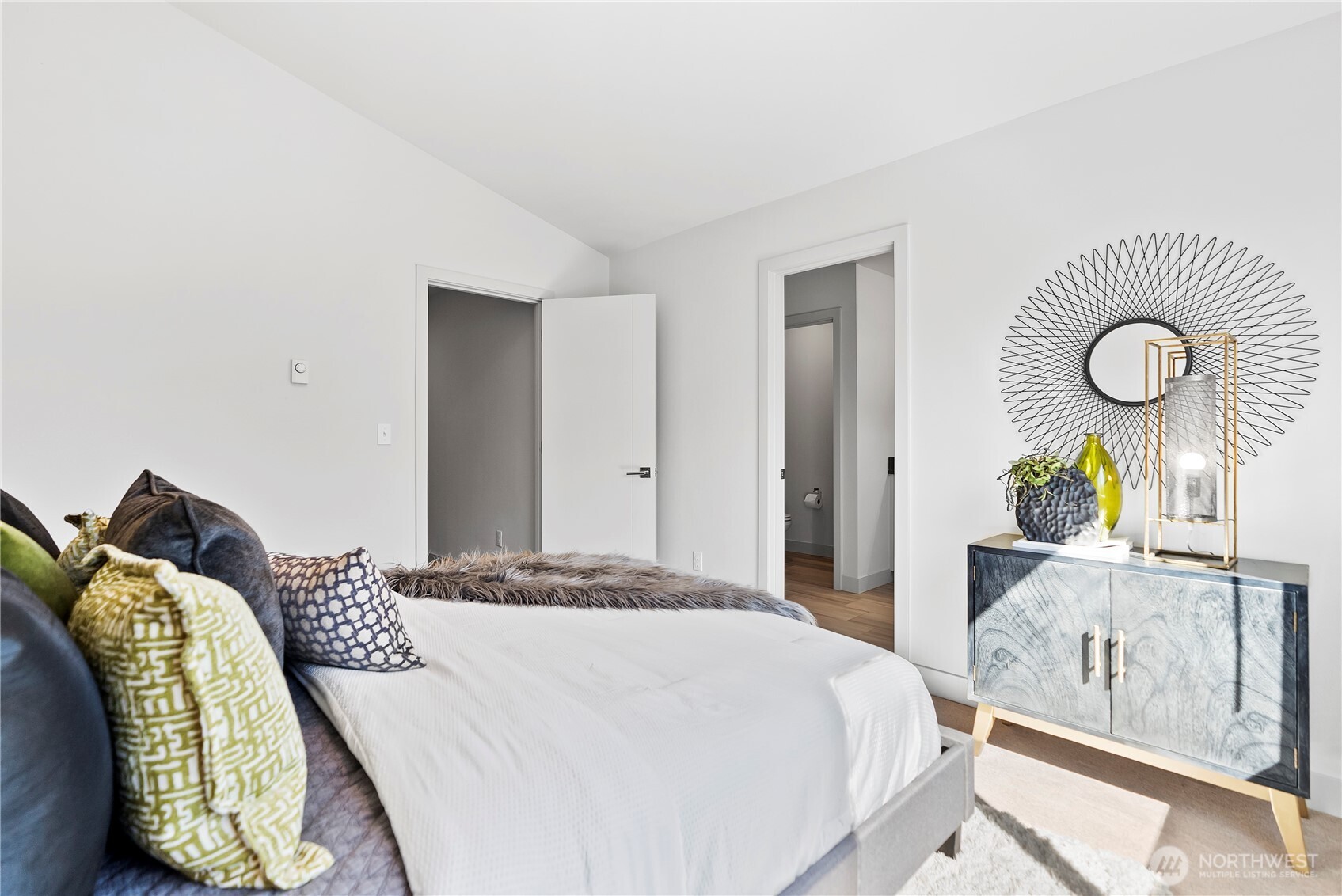 17905 35th Avenue Southeast, Unit A1 Bothell, WA 98012 - Photo 31 of 36 a bedroom with a bed and chandelier