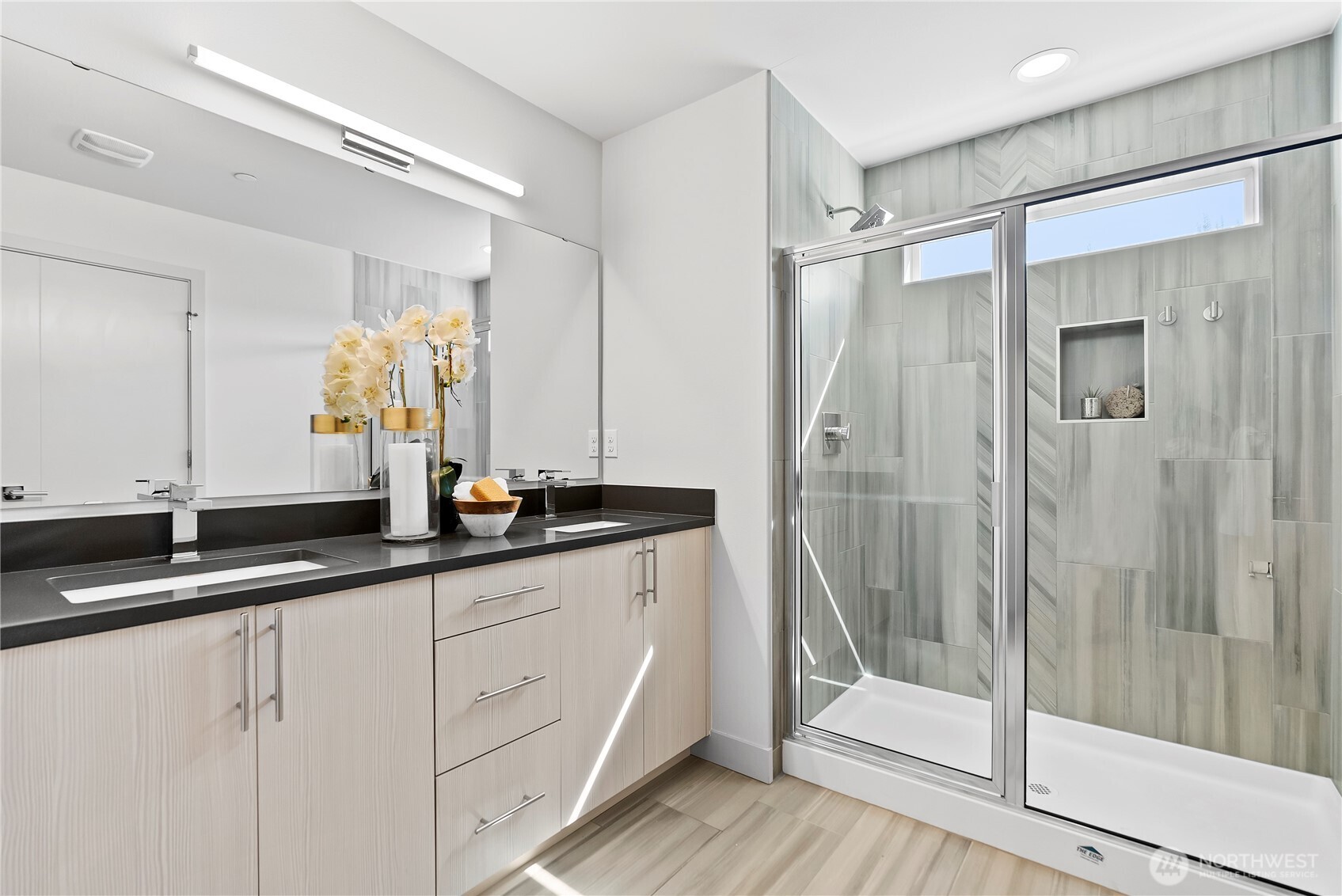 17905 35th Avenue Southeast, Unit A1 Bothell, WA 98012 - Photo 33 of 36 a bathroom with a double vanity sink and mirror