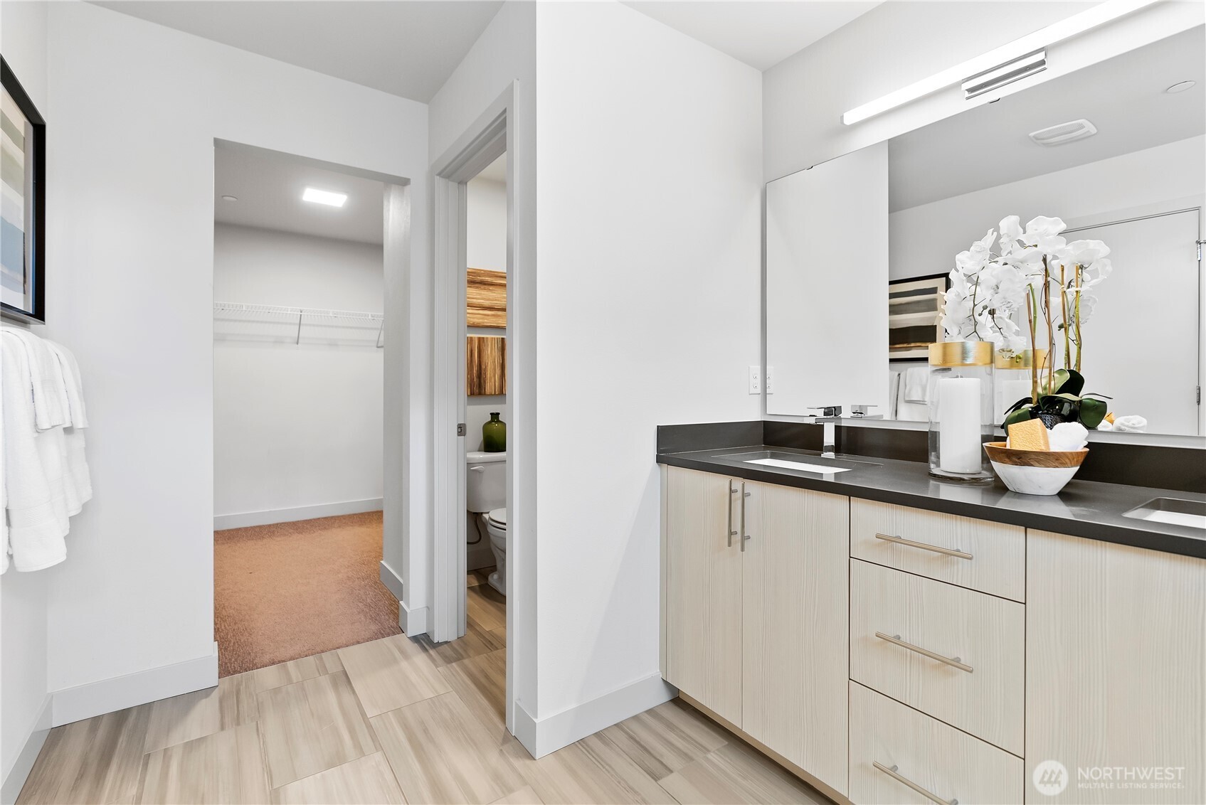 17905 35th Avenue Southeast, Unit A1 Bothell, WA 98012 - Photo 34 of 36 a bathroom with a double vanity sink a mirror and a shower