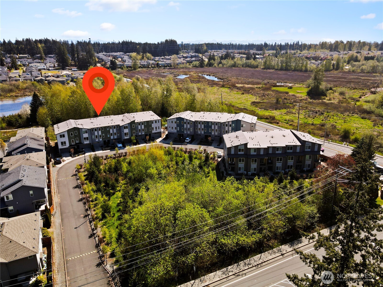 17905 35th Avenue Southeast, Unit A1 Bothell, WA 98012 - Photo 35 of 36 a view of a lake with lawn chairs and a dining table