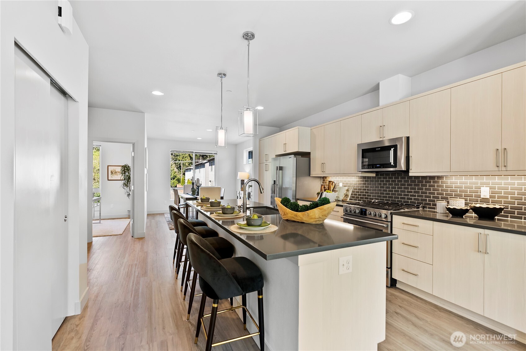 17905 35th Avenue Southeast, Unit A1 Bothell, WA 98012 - Photo 7 of 36 a kitchen with stainless steel appliances granite countertop a stove top oven a sink a refrigerator white cabinets and wooden floor