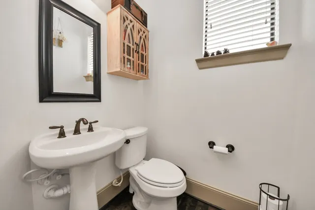 a bathroom with a granite countertop tub sink and mirror
