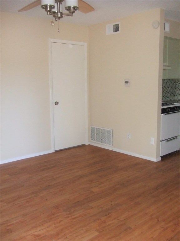 2800 Swisher Street, Unit 217 Austin, TX 78705 - Photo 3 of 5 a view of empty room with wooden floor and fan
