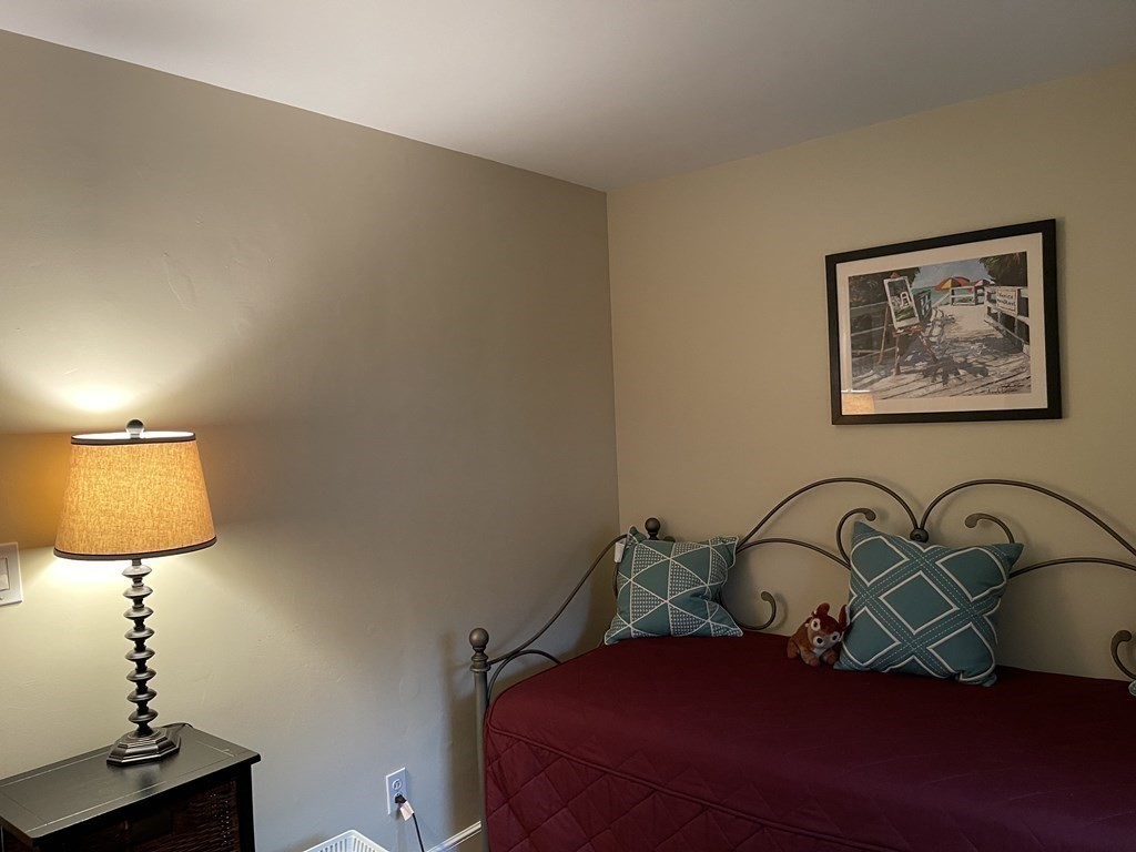 223 Governors Road Quincy, MA 02169 - Photo 22 of 40 a bedroom with a bed and a lamp on the table