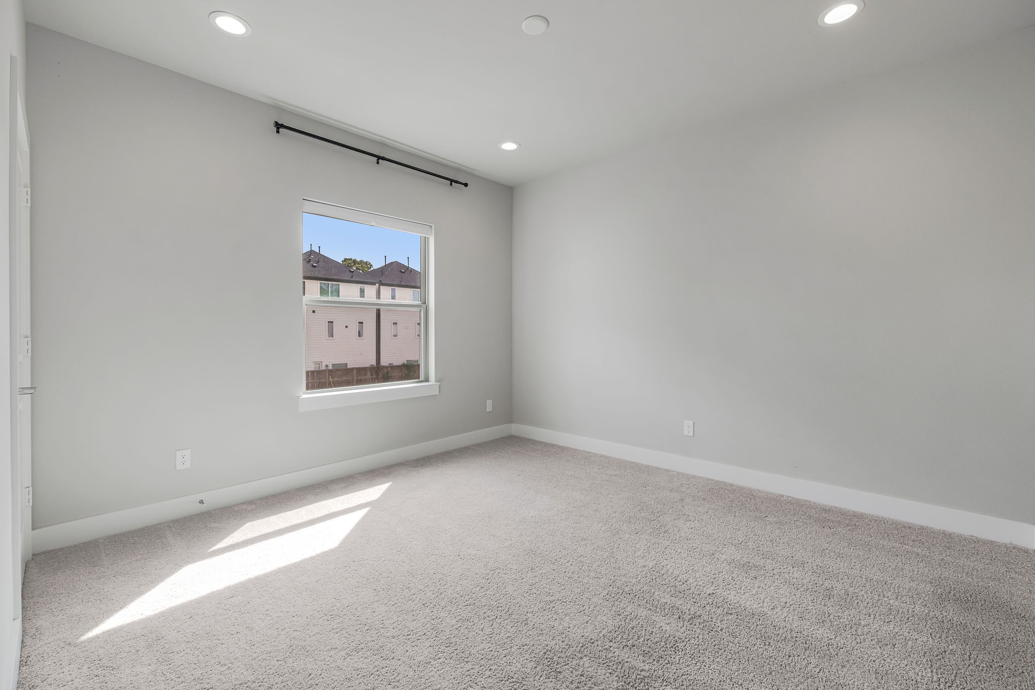 540 Janisch Road, Unit A Houston, TX 77018 - Photo 16 of 18 Bright secondary bedroom with plush carpeting, recessed lighting, and generous natural light.
