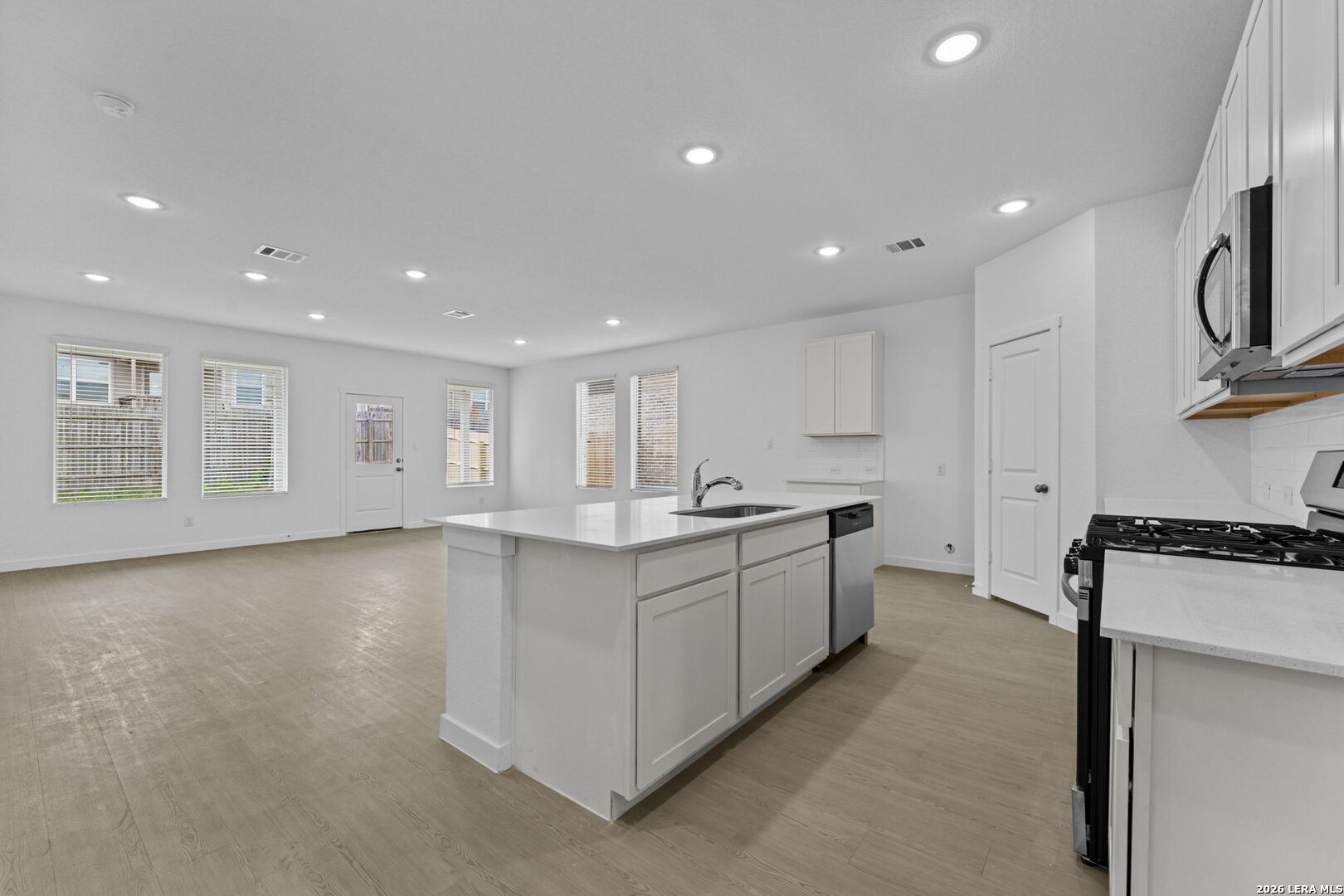 2319 Fort Davis Pass Marion, TX 78124 - Photo 15 of 24 a large kitchen with stainless steel appliances granite countertop a lot of counter space and wooden floor