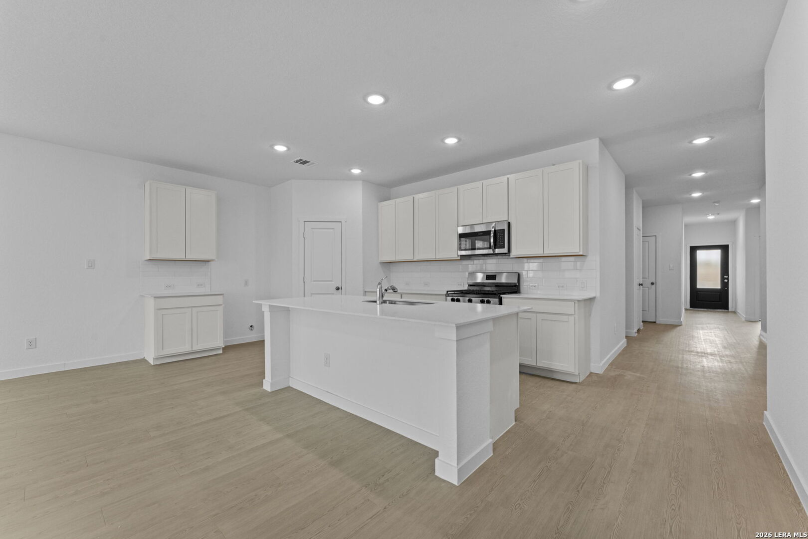 2319 Fort Davis Pass Marion, TX 78124 - Photo 16 of 24 a kitchen with white cabinets and stainless steel appliances