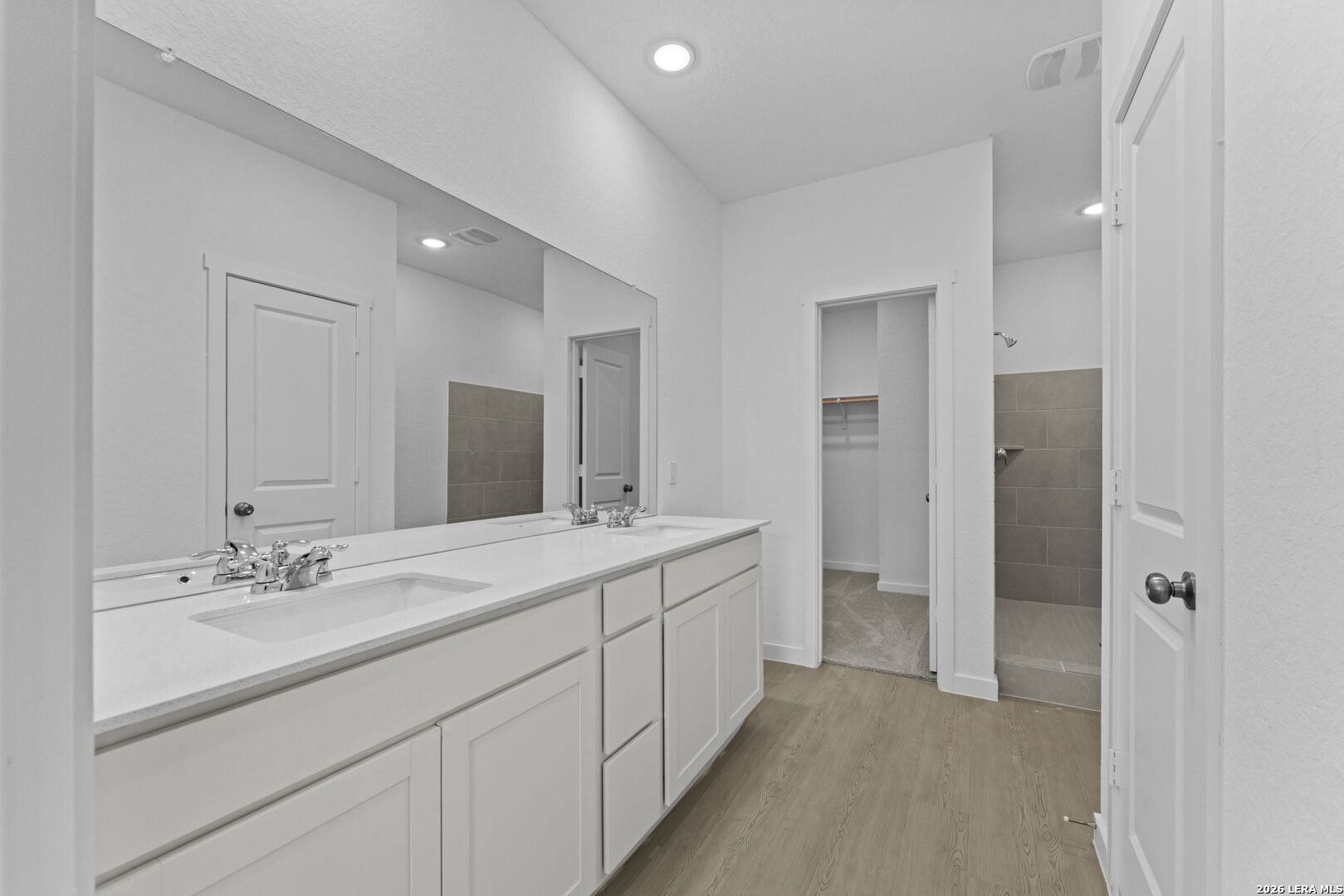 2319 Fort Davis Pass Marion, TX 78124 - Photo 22 of 24 a spacious bathroom with a double vanity sink mirror and shower