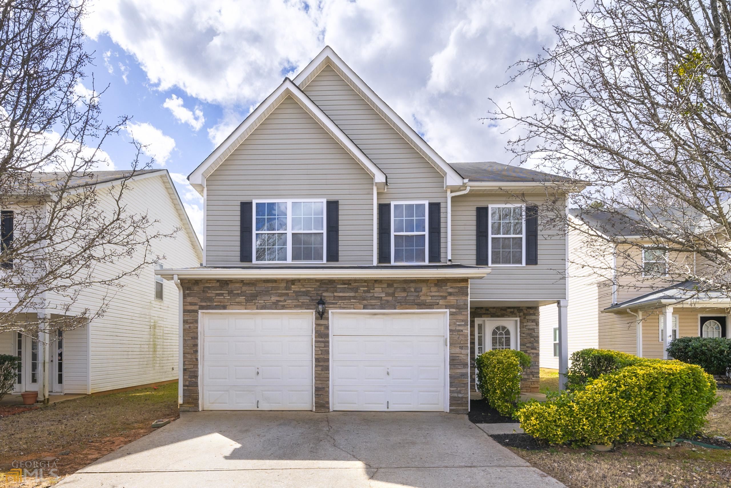 3034 Summer Breeze Drive Villa Rica, GA 30180 - Photo 1 of 1 a view of a white house next to a yard