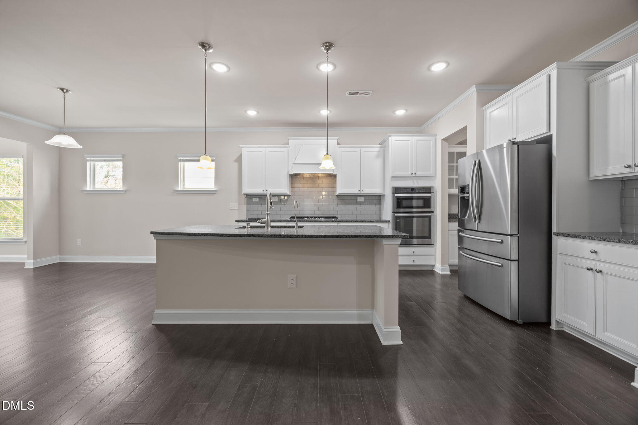 2048 Crampton Grove Way Cary, NC 27519 - Photo 9 of 50 a large kitchen with stainless steel appliances kitchen island a large counter top a sink a refrigerator and a window