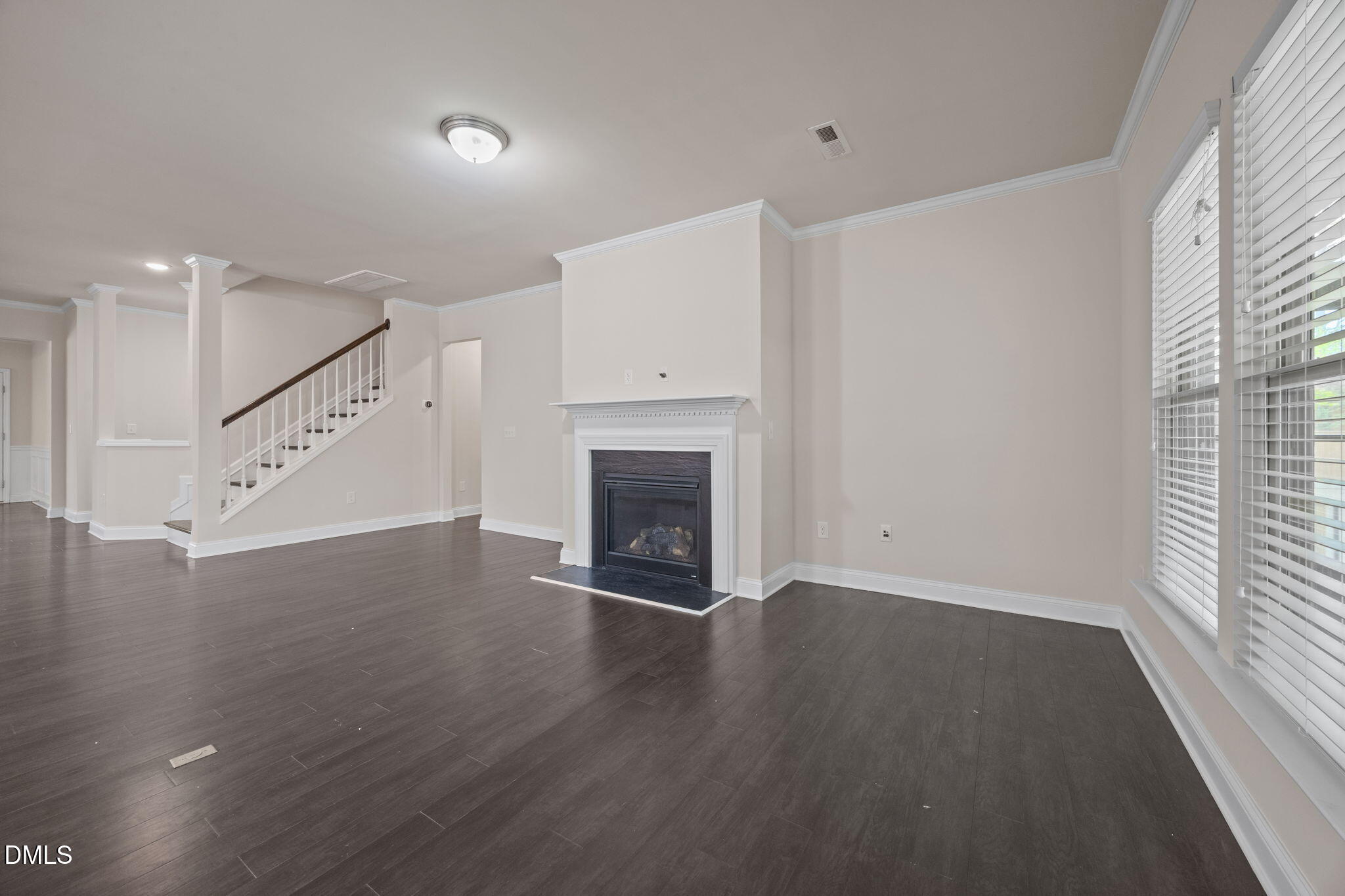 2048 Crampton Grove Way Cary, NC 27519 - Photo 10 of 50 a view of an empty room with wooden floor fireplace and a window
