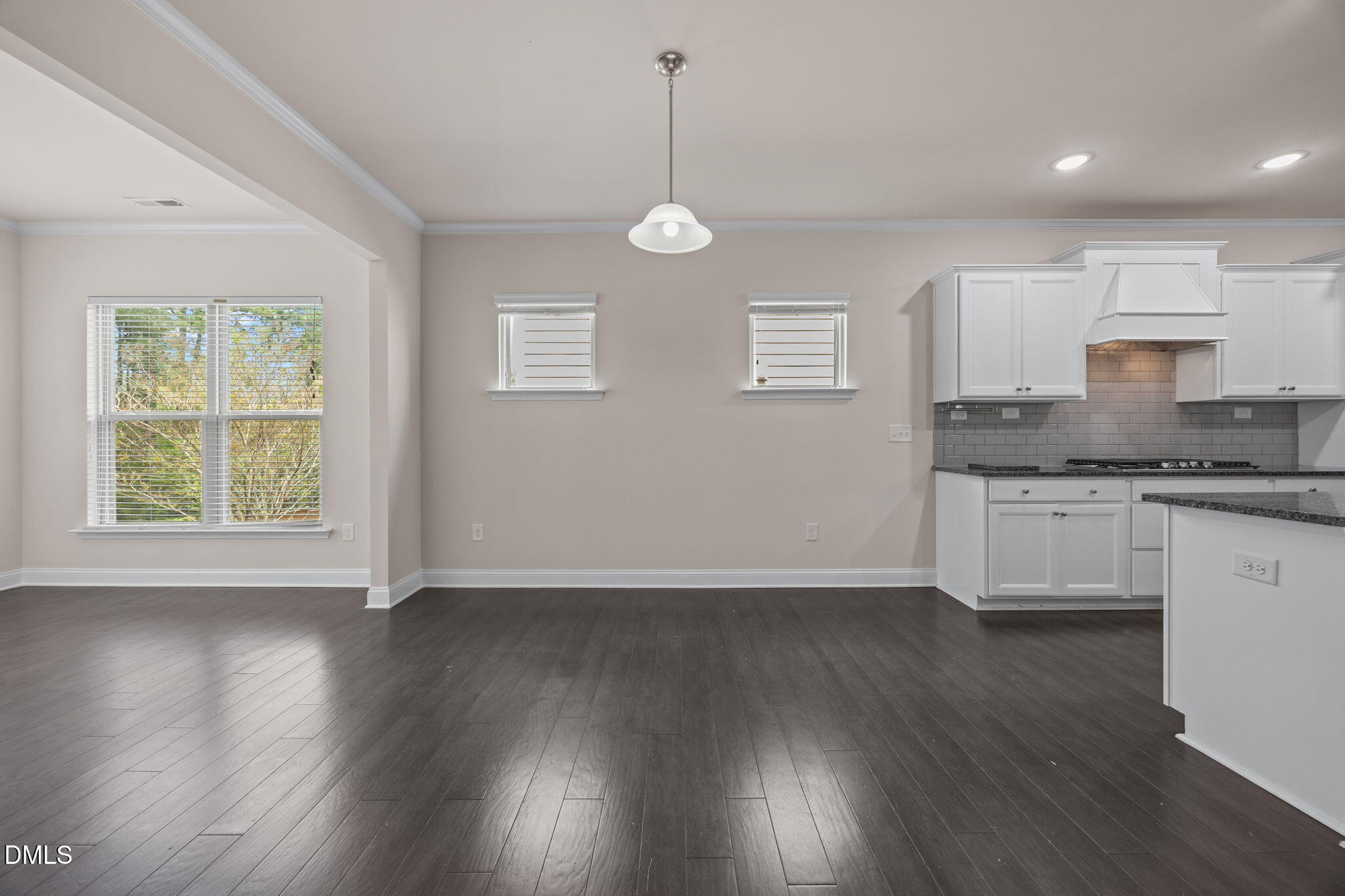 2048 Crampton Grove Way Cary, NC 27519 - Photo 11 of 50 a kitchen with granite countertop a stove a sink and wooden floor