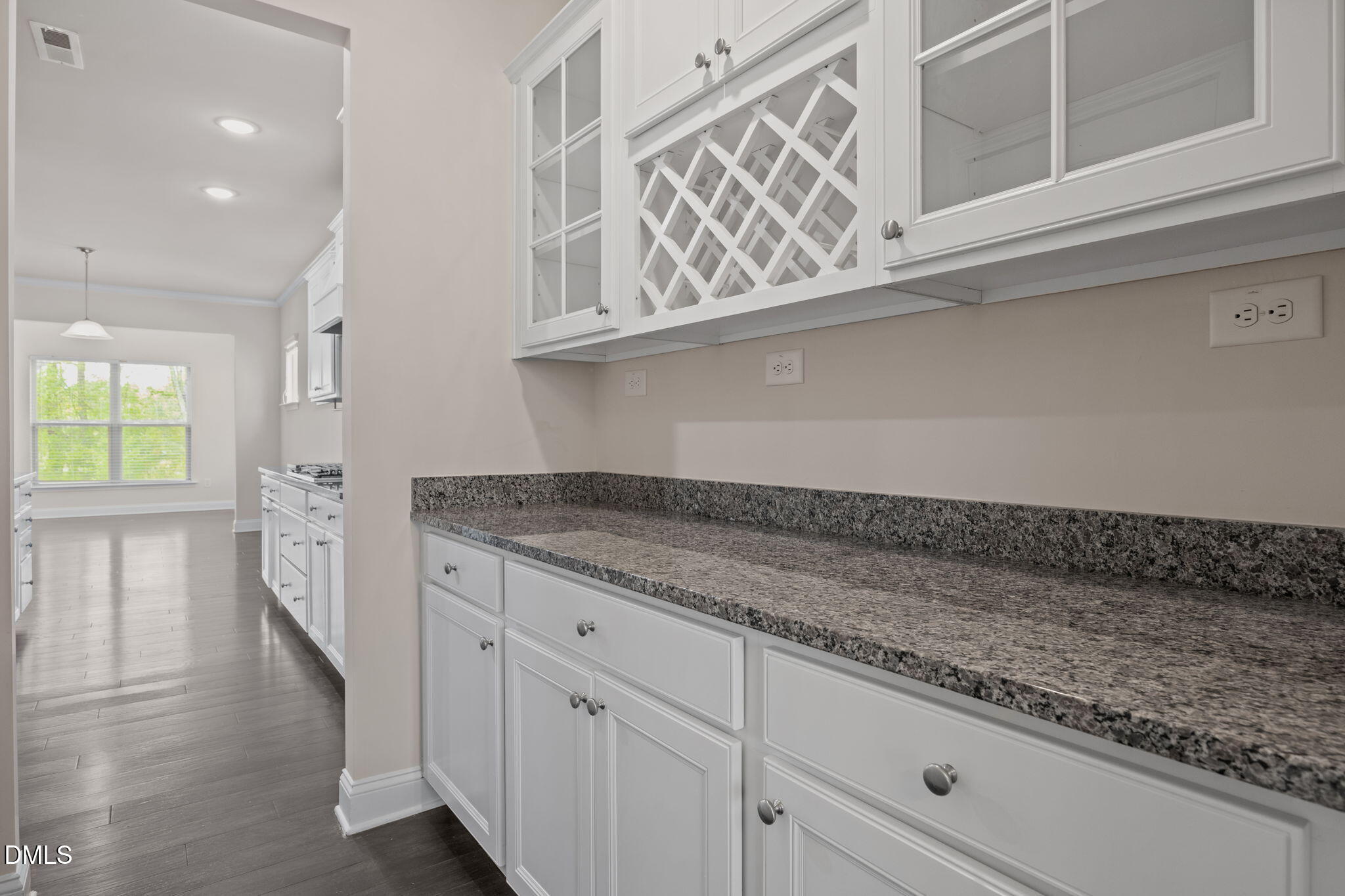 2048 Crampton Grove Way Cary, NC 27519 - Photo 20 of 50 a kitchen with granite countertop white cabinets and a wooden floor