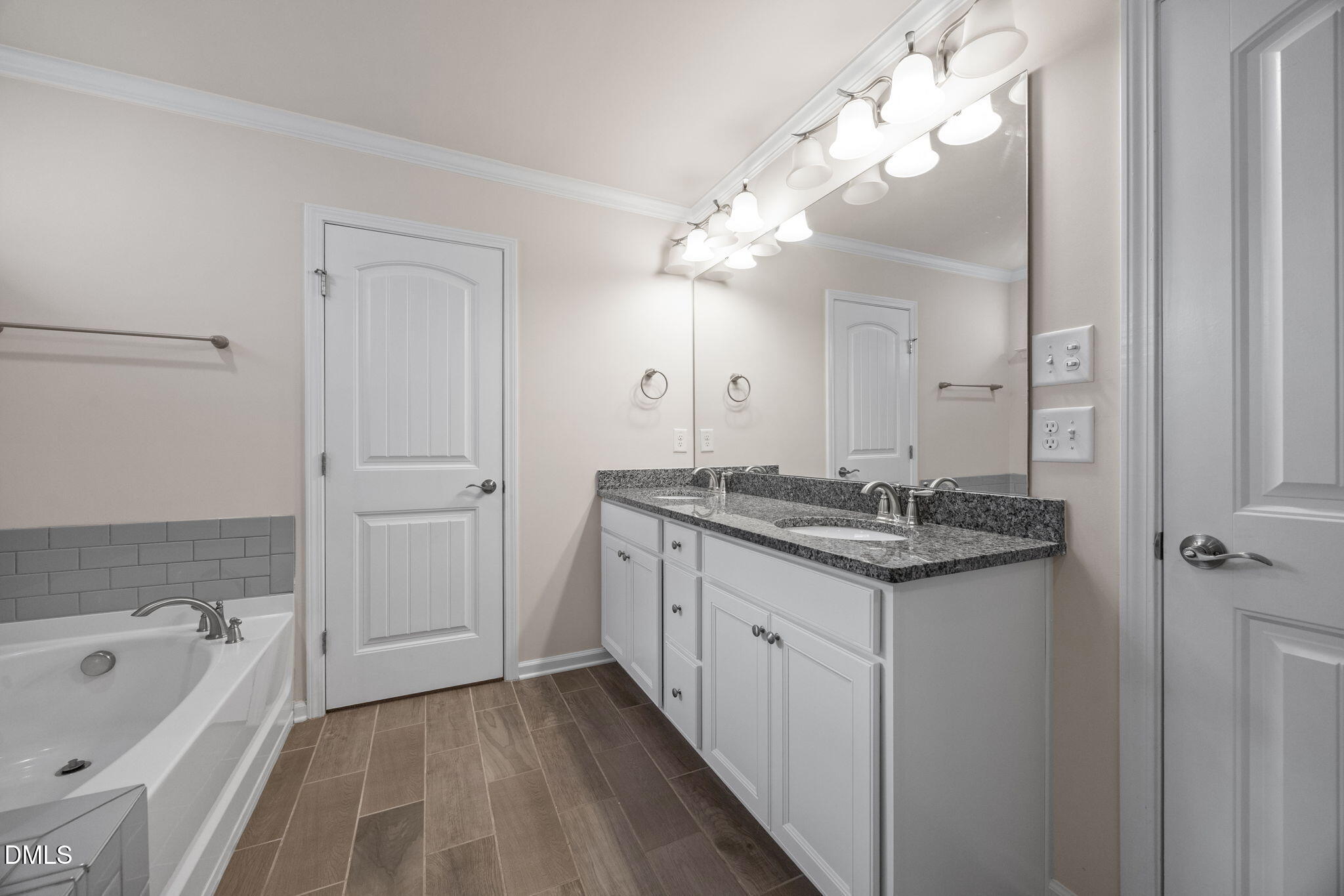 2048 Crampton Grove Way Cary, NC 27519 - Photo 21 of 50 a bathroom with a granite countertop sink a large mirror and a bathtub