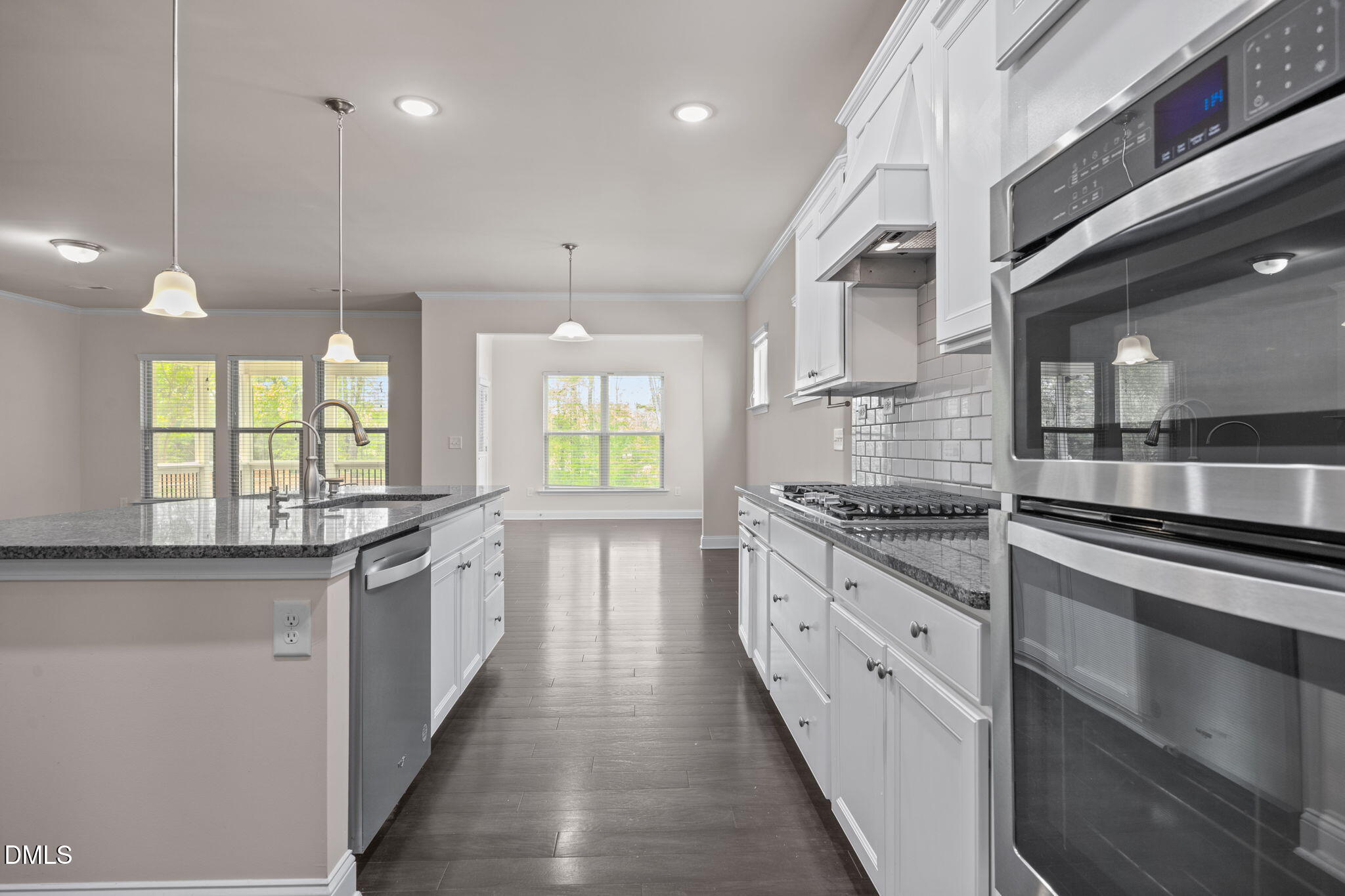 2048 Crampton Grove Way Cary, NC 27519 - Photo 47 of 50 a large kitchen with stainless steel appliances granite countertop a stove and a sink