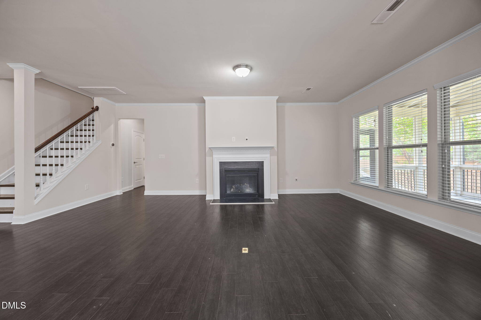 2048 Crampton Grove Way Cary, NC 27519 - Photo 6 of 50 an empty room with wooden floor fireplace and windows
