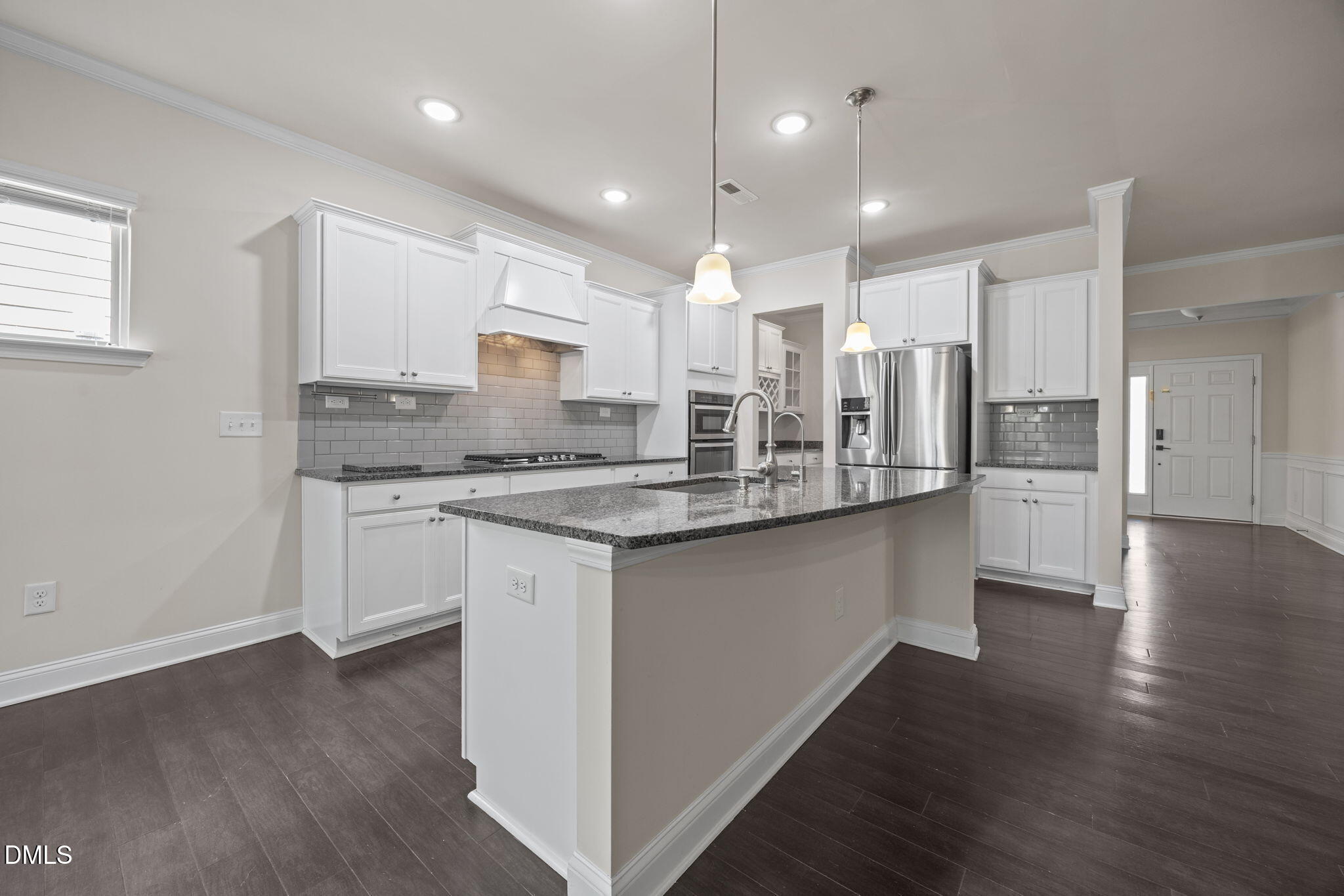 2048 Crampton Grove Way Cary, NC 27519 - Photo 8 of 50 a large kitchen with stainless steel appliances kitchen island granite countertop a large counter top and stove a sink with wooden floors