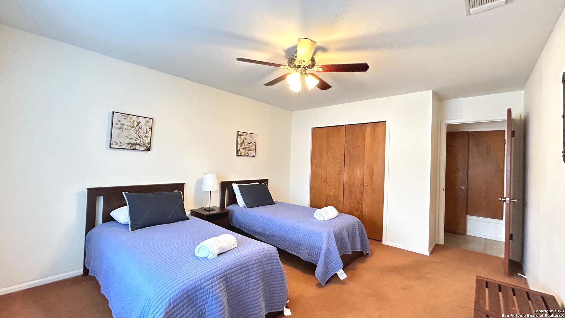 6216 Rue Marielyne Street Leon Valley, TX 78238 - Photo 13 of 35 a bedroom with two beds and a chandelier