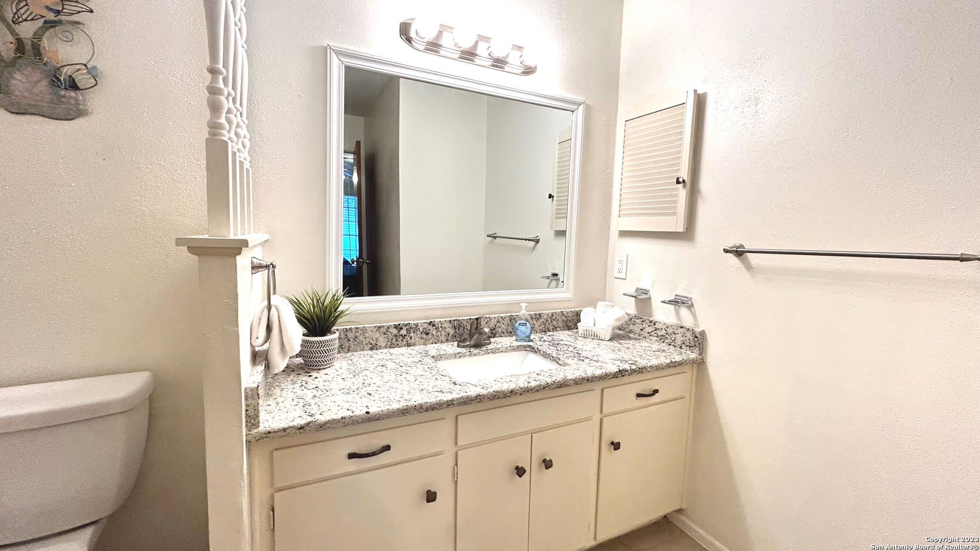 6216 Rue Marielyne Street Leon Valley, TX 78238 - Photo 26 of 35 a bathroom with a granite countertop sink and a mirror