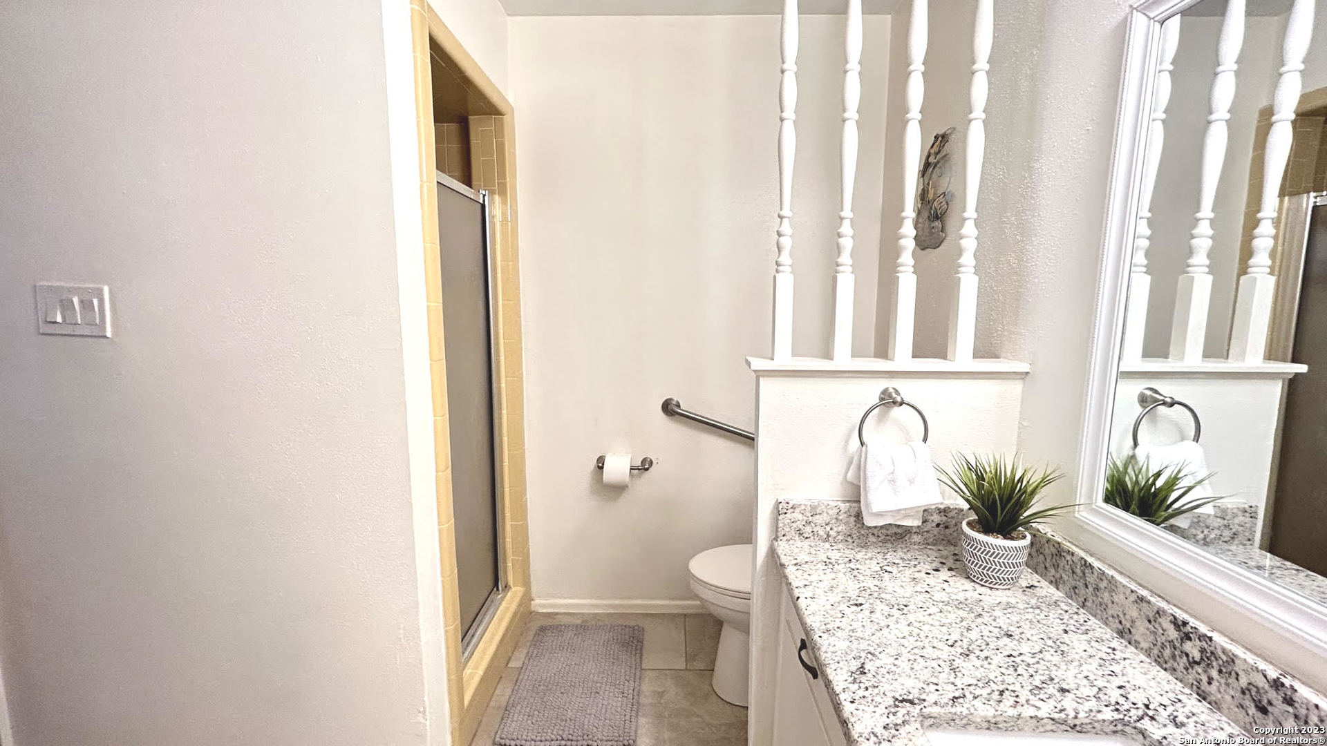 6216 Rue Marielyne Street Leon Valley, TX 78238 - Photo 29 of 35 a bathroom with a granite countertop sink a toilet and shower