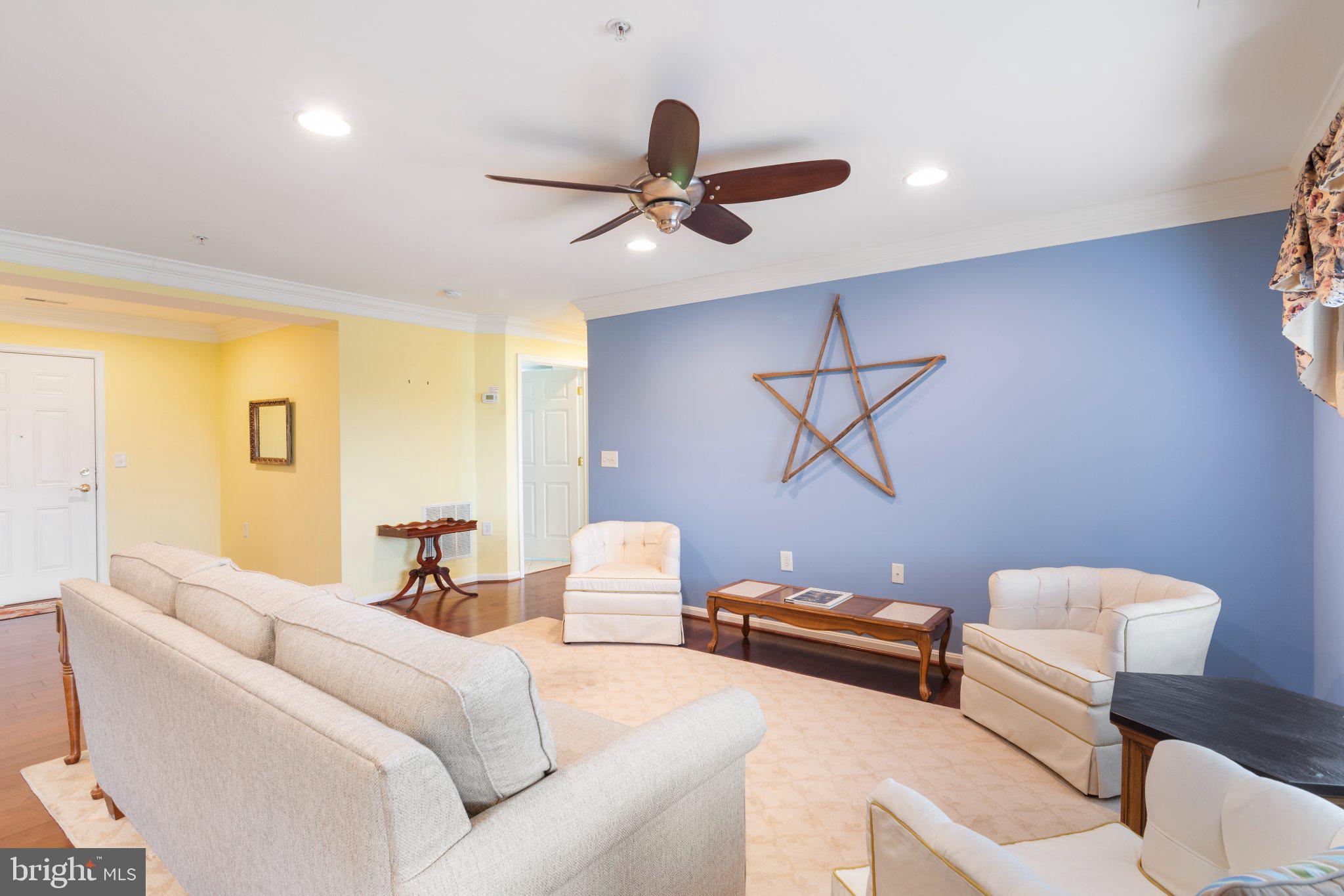 12236 Roundwood Road, Unit 609 Lutherville-Timonium, MD 21093 - Photo 16 of 40 a living room with furniture and a ceiling fan