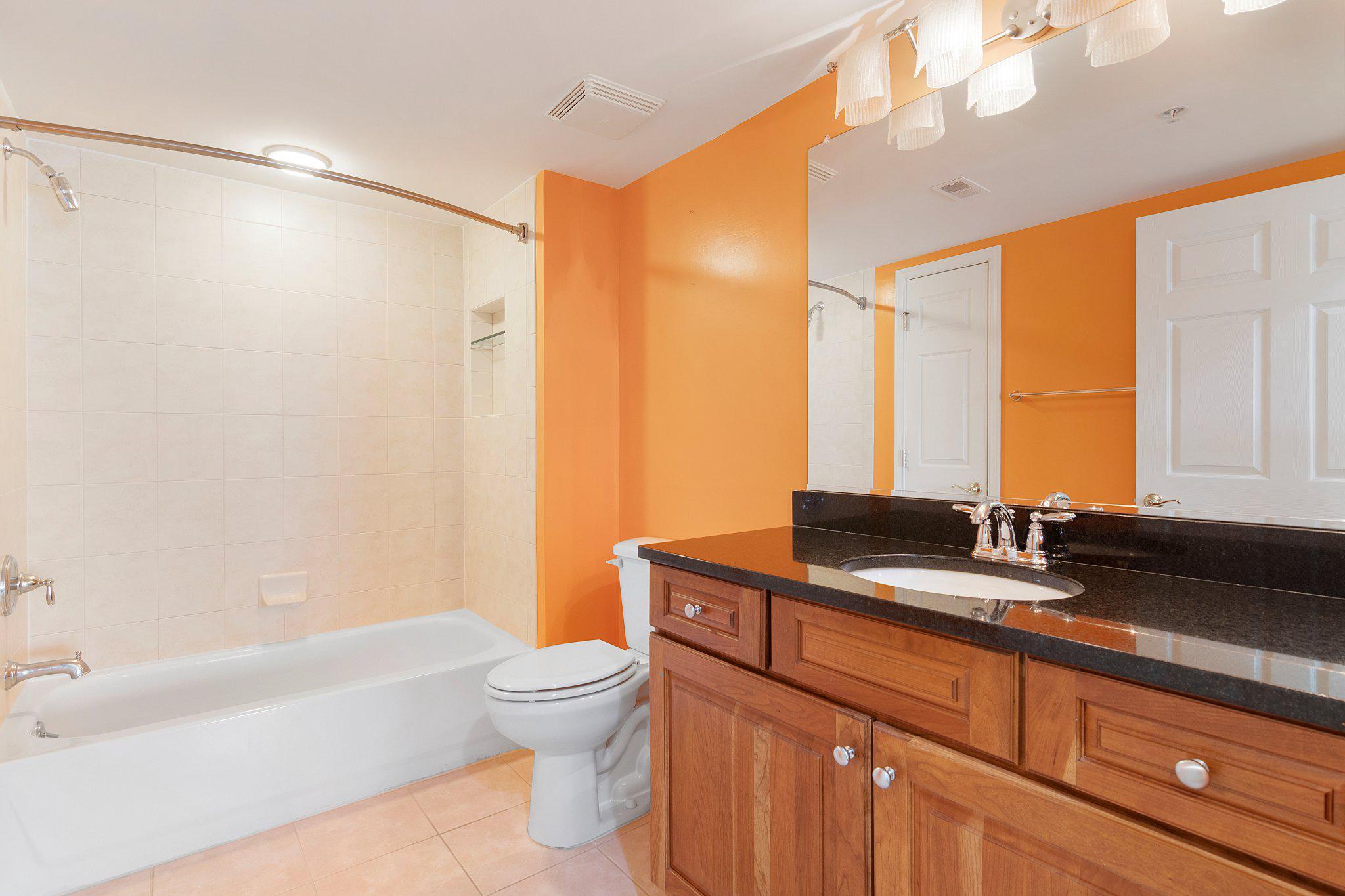 12236 Roundwood Road, Unit 609 Lutherville-Timonium, MD 21093 - Photo 23 of 40 a bathroom with a granite countertop sink toilet and shower