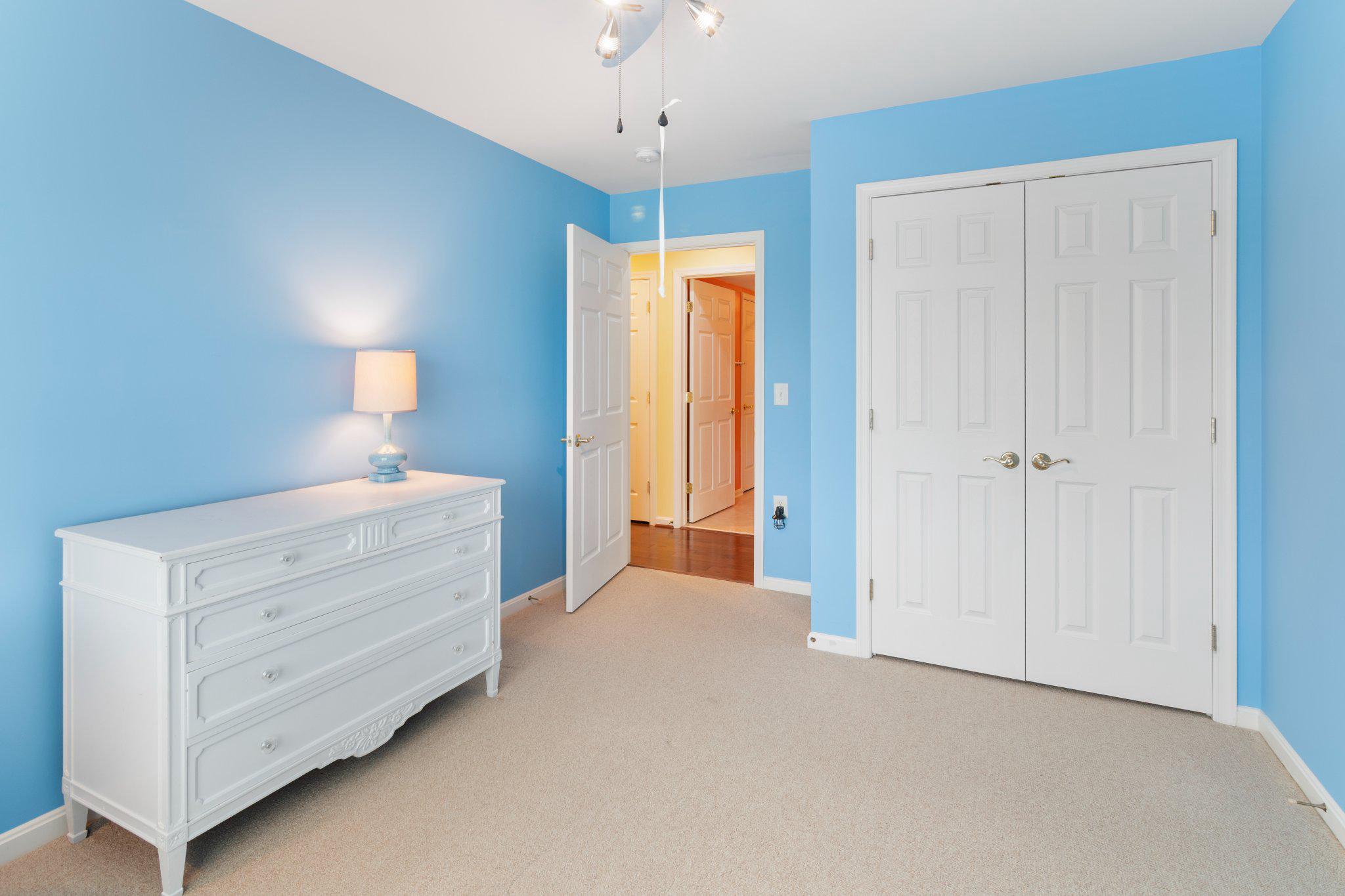 12236 Roundwood Road, Unit 609 Lutherville-Timonium, MD 21093 - Photo 25 of 40 a room with a bed a dresser and a window