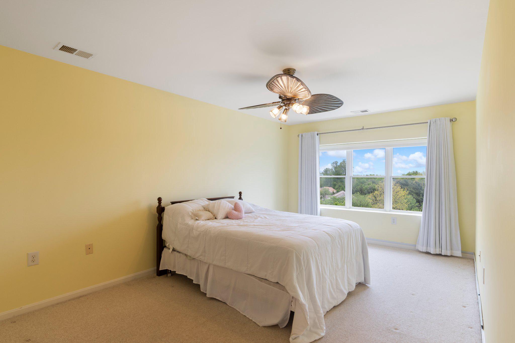 12236 Roundwood Road, Unit 609 Lutherville-Timonium, MD 21093 - Photo 28 of 40 a bedroom with a bed and a chandelier