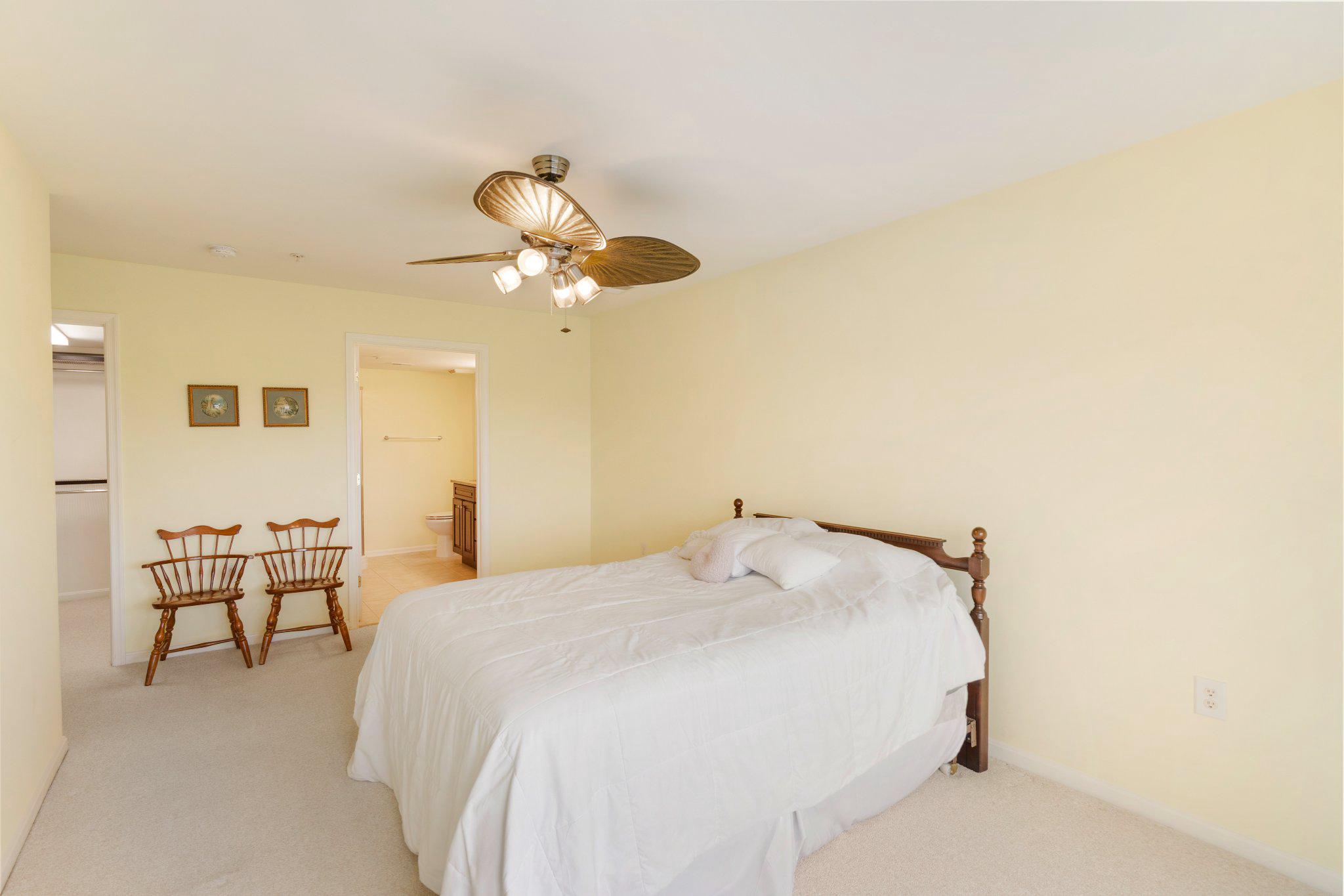 12236 Roundwood Road, Unit 609 Lutherville-Timonium, MD 21093 - Photo 29 of 40 a bedroom with a bed and a chandelier