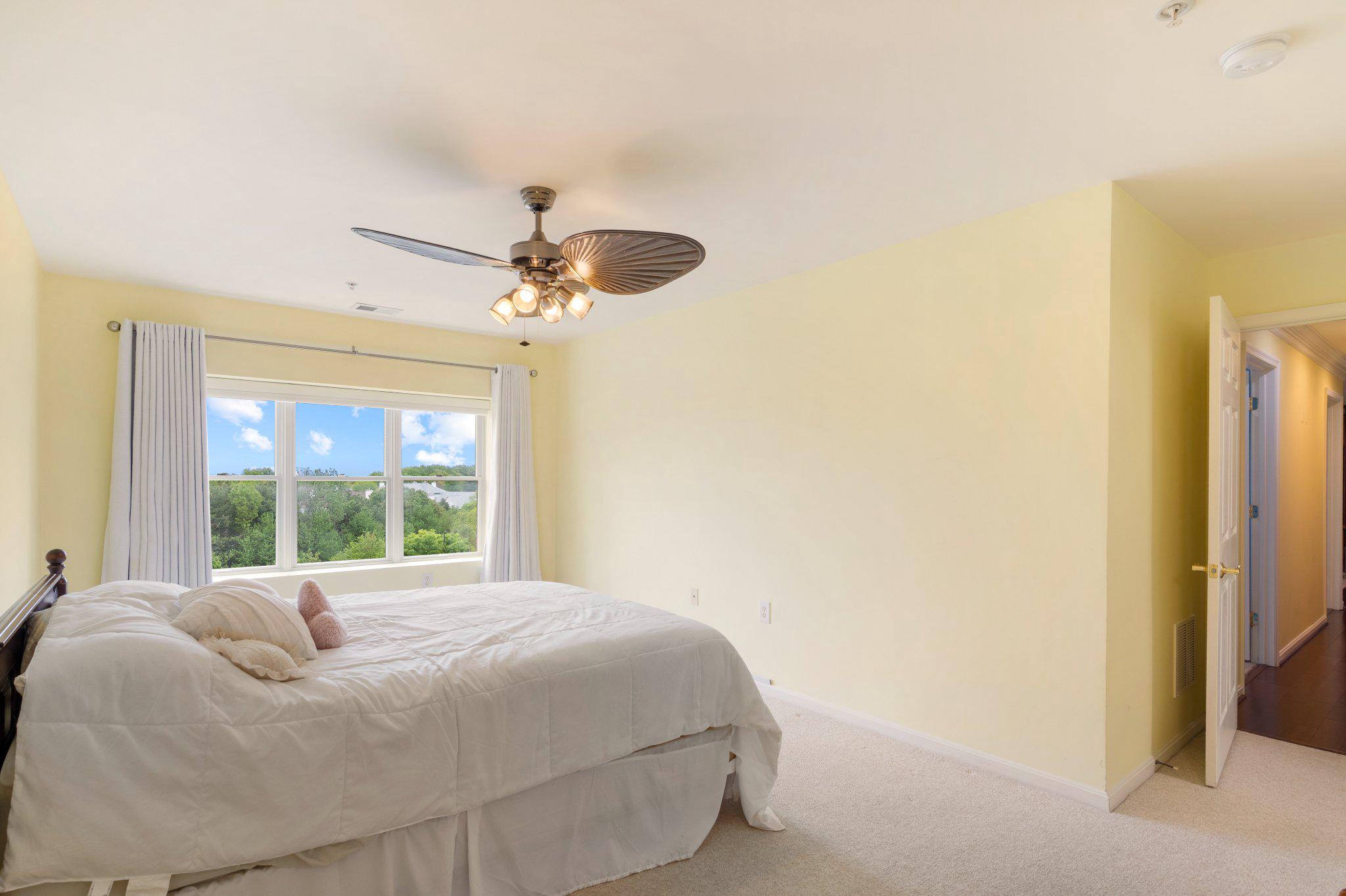 12236 Roundwood Road, Unit 609 Lutherville-Timonium, MD 21093 - Photo 30 of 40 a large bed sitting in a bedroom next to a window