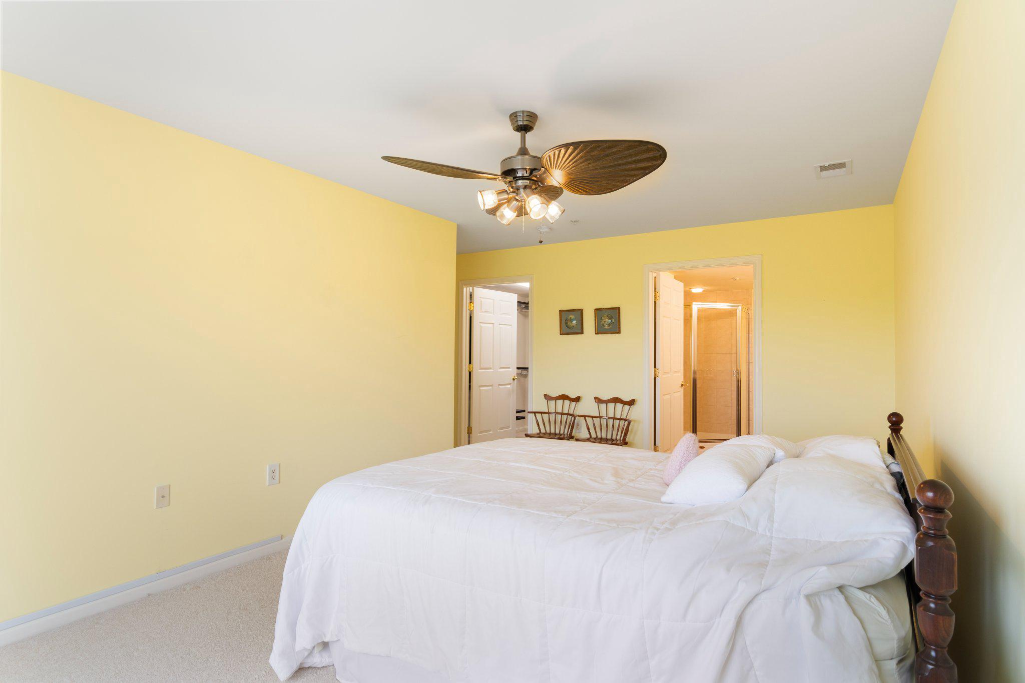 12236 Roundwood Road, Unit 609 Lutherville-Timonium, MD 21093 - Photo 31 of 40 a bedroom with a bed and a chandelier