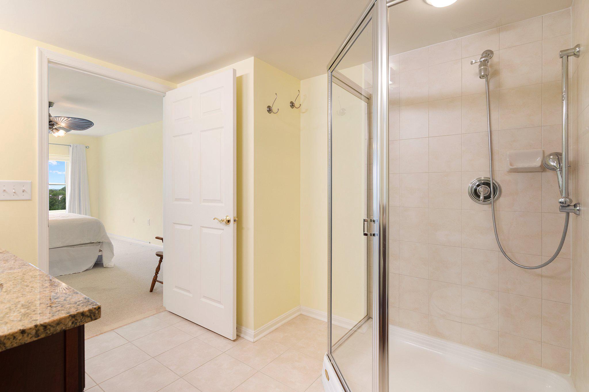12236 Roundwood Road, Unit 609 Lutherville-Timonium, MD 21093 - Photo 33 of 40 a bathroom with a granite countertop shower mirror and a sink