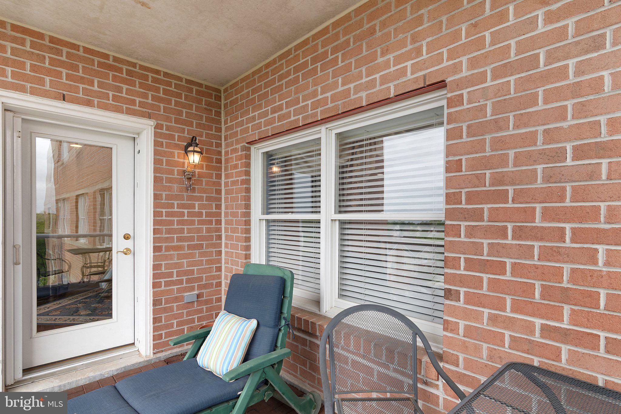 12236 Roundwood Road, Unit 609 Lutherville-Timonium, MD 21093 - Photo 36 of 40 a view of a chair and table in a patio