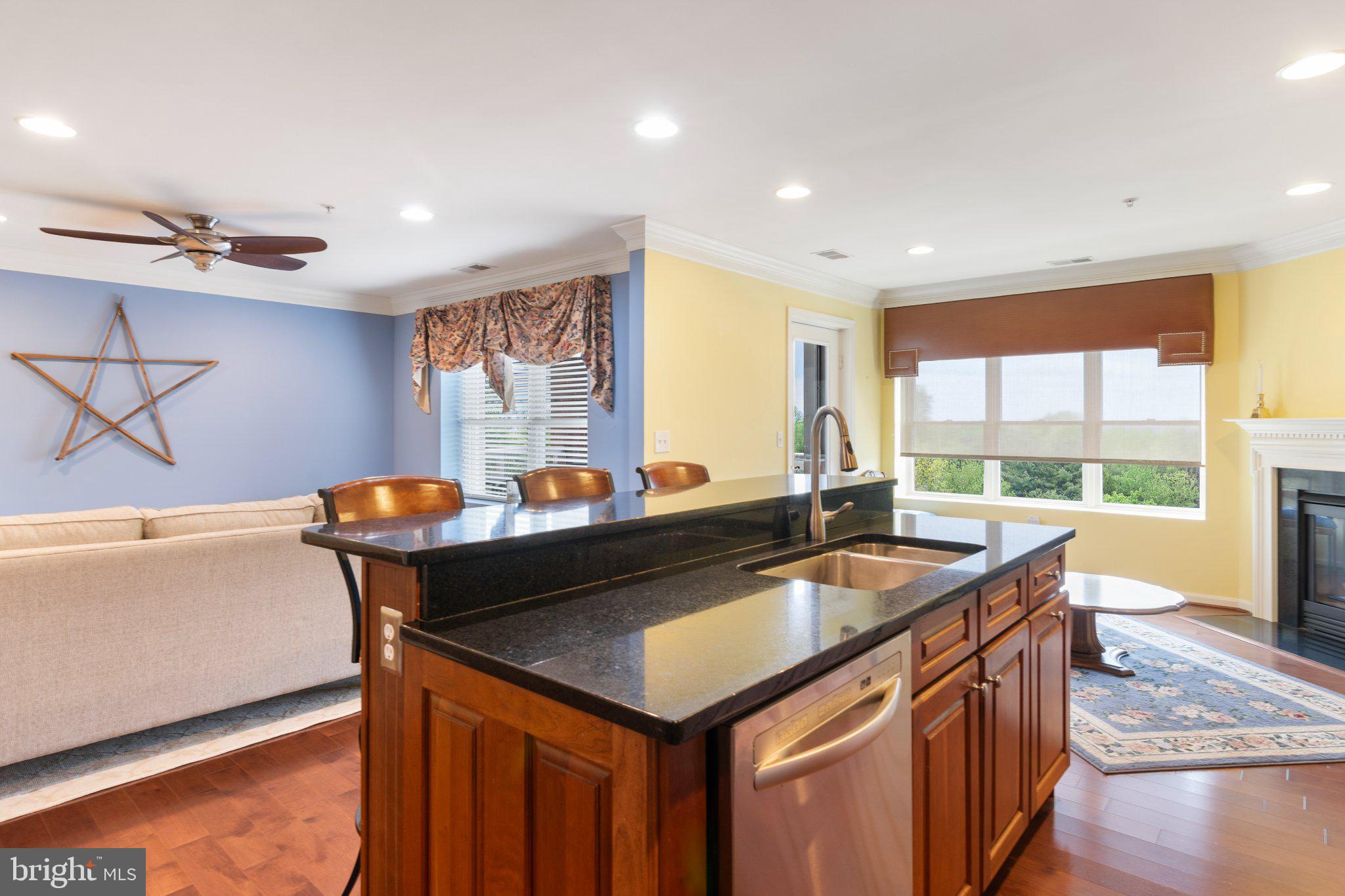 12236 Roundwood Road, Unit 609 Lutherville-Timonium, MD 21093 - Photo 9 of 40 a kitchen with a stove a sink and a wooden cabinets