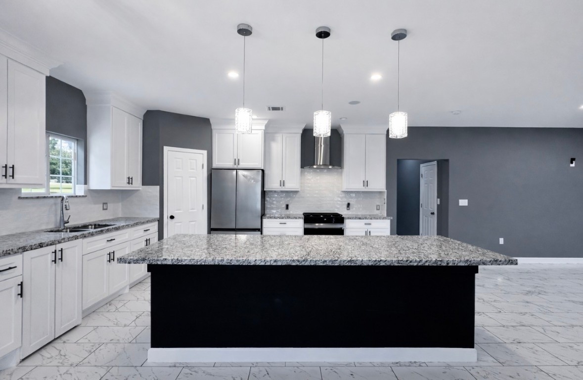 5125 Larkspur Street Houston, TX 77033 - Photo 16 of 33 a large kitchen with granite countertop a sink and white cabinets
