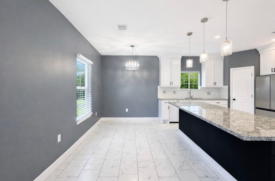 5125 Larkspur Street Houston, TX 77033 - Photo 17 of 33 a large kitchen with a large counter top sink and stainless steel appliances