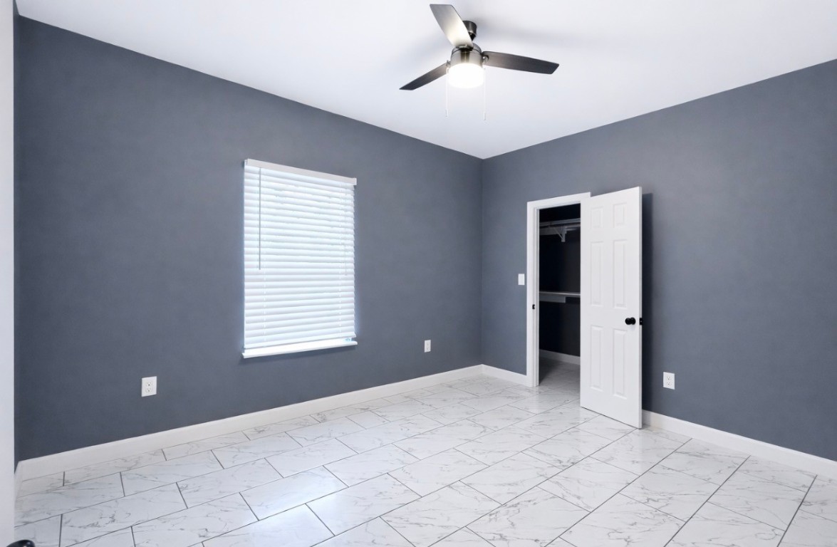 5125 Larkspur Street Houston, TX 77033 - Photo 29 of 33 a view of an empty room with window and chandelier fan