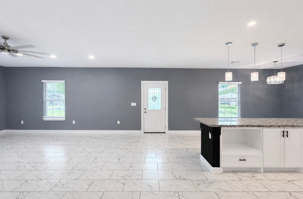 5125 Larkspur Street Houston, TX 77033 - Photo 7 of 33 a view of an empty room with window and wooden floor