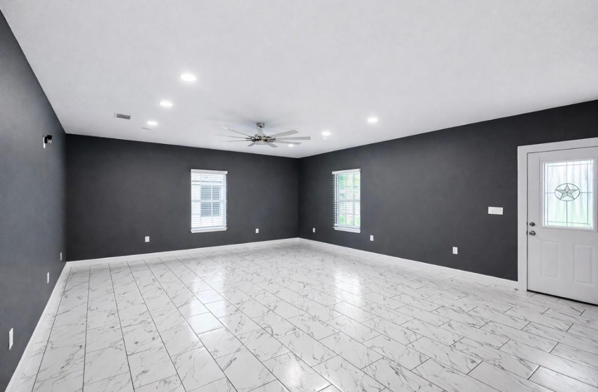 5125 Larkspur Street Houston, TX 77033 - Photo 10 of 33 a view of an empty room with window and wooden floor
