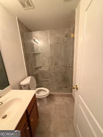 a bathroom with a toilet and shower
