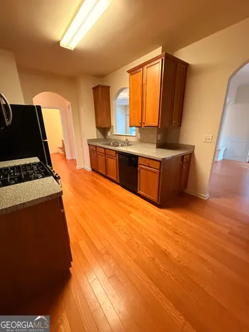 a stove top oven sitting inside of a kitchen