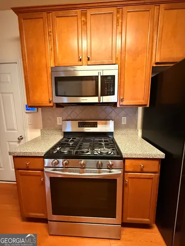 a kitchen with a sink appliances and cabinets