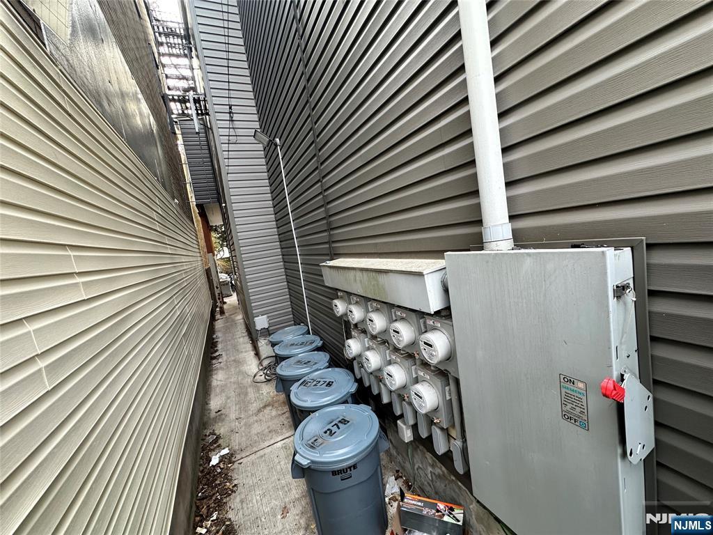 276 Ellison Street Paterson, NJ 07501 - Photo 14 of 22 a bathroom with a toilet and shower curtain