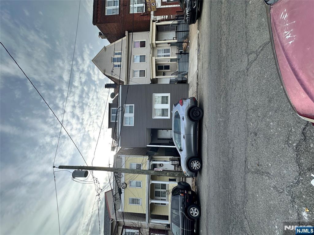 276 Ellison Street Paterson, NJ 07501 - Photo 2 of 22 a car parked in front of building