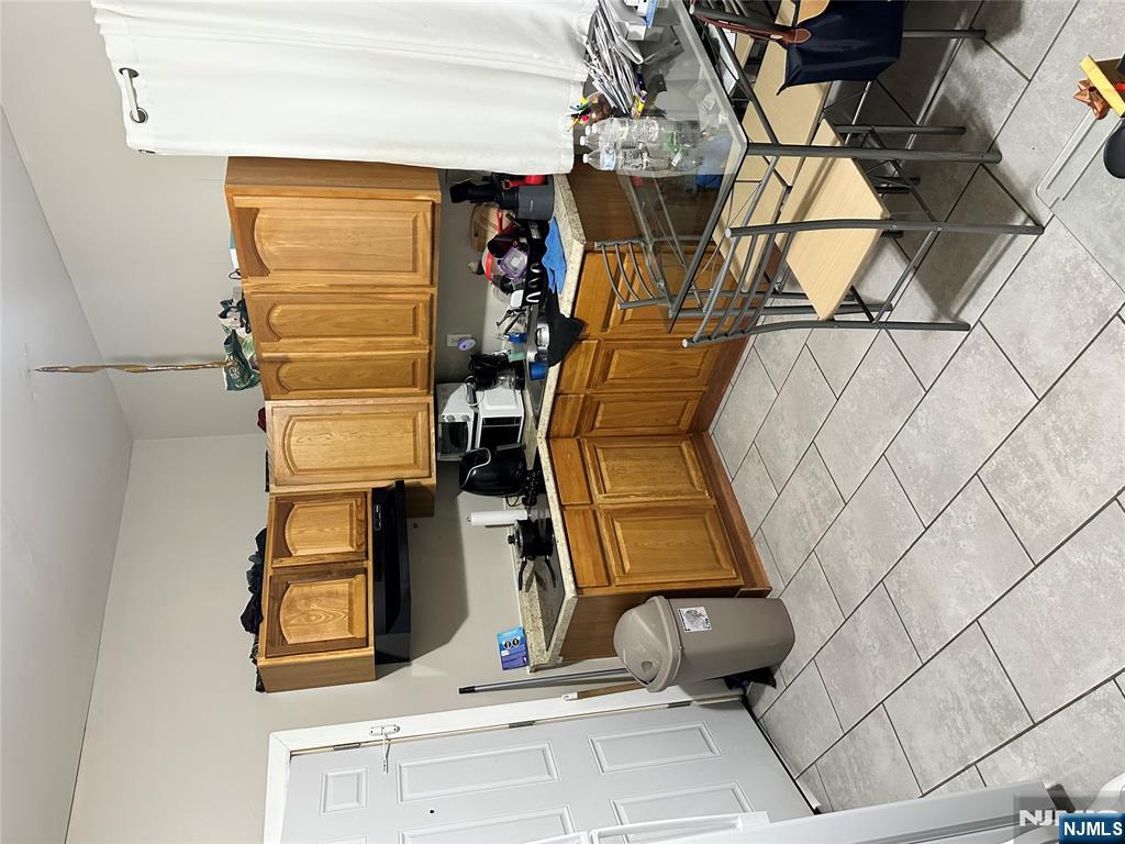 276 Ellison Street Paterson, NJ 07501 - Photo 6 of 22 a kitchen with a sink a stove and cabinets
