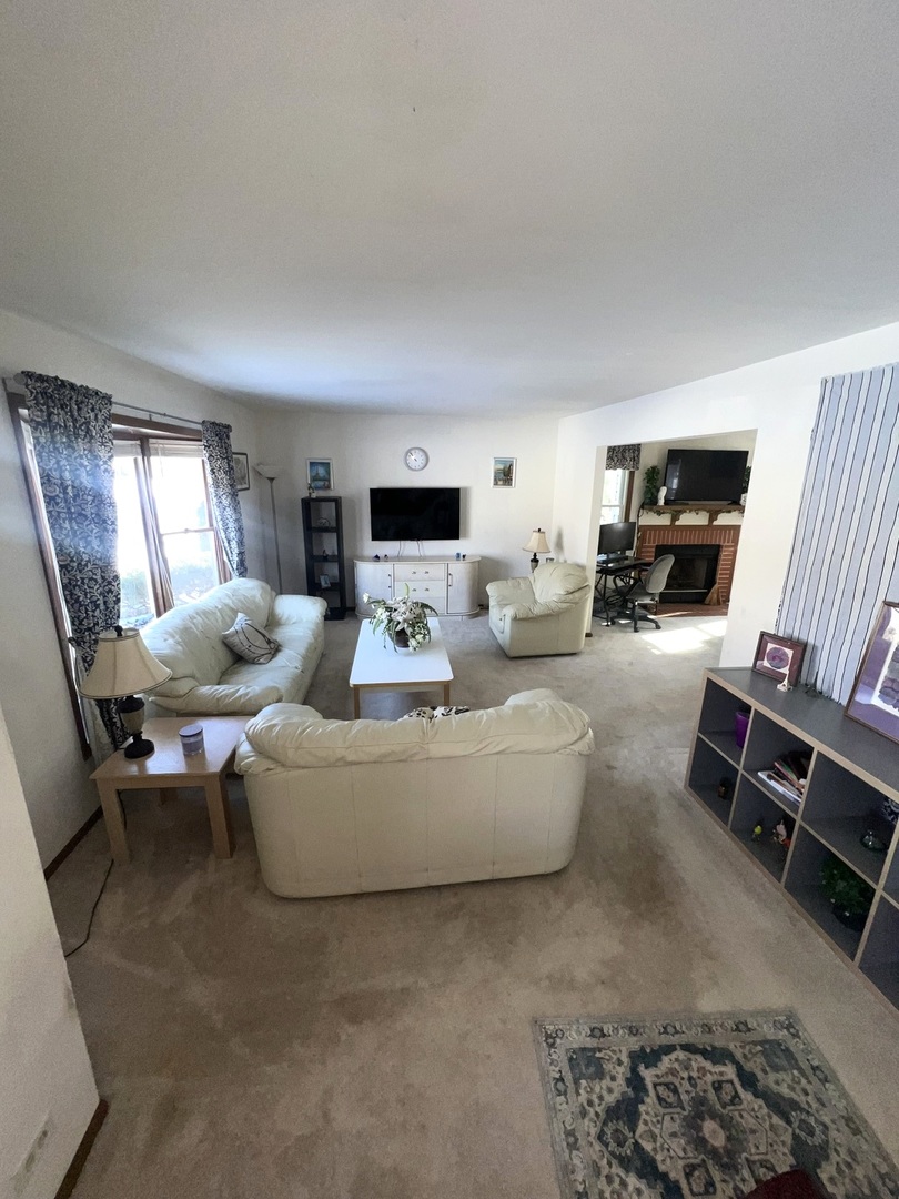 1018 Rain Tree Drive Bolingbrook, IL 60440 - Photo 2 of 22 a living room with furniture and a flat screen tv