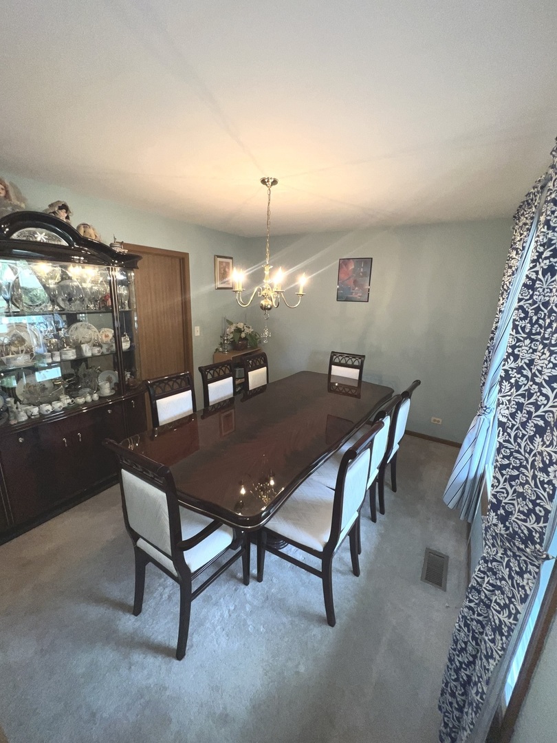 1018 Rain Tree Drive Bolingbrook, IL 60440 - Photo 6 of 22 a living room with furniture and a chandelier