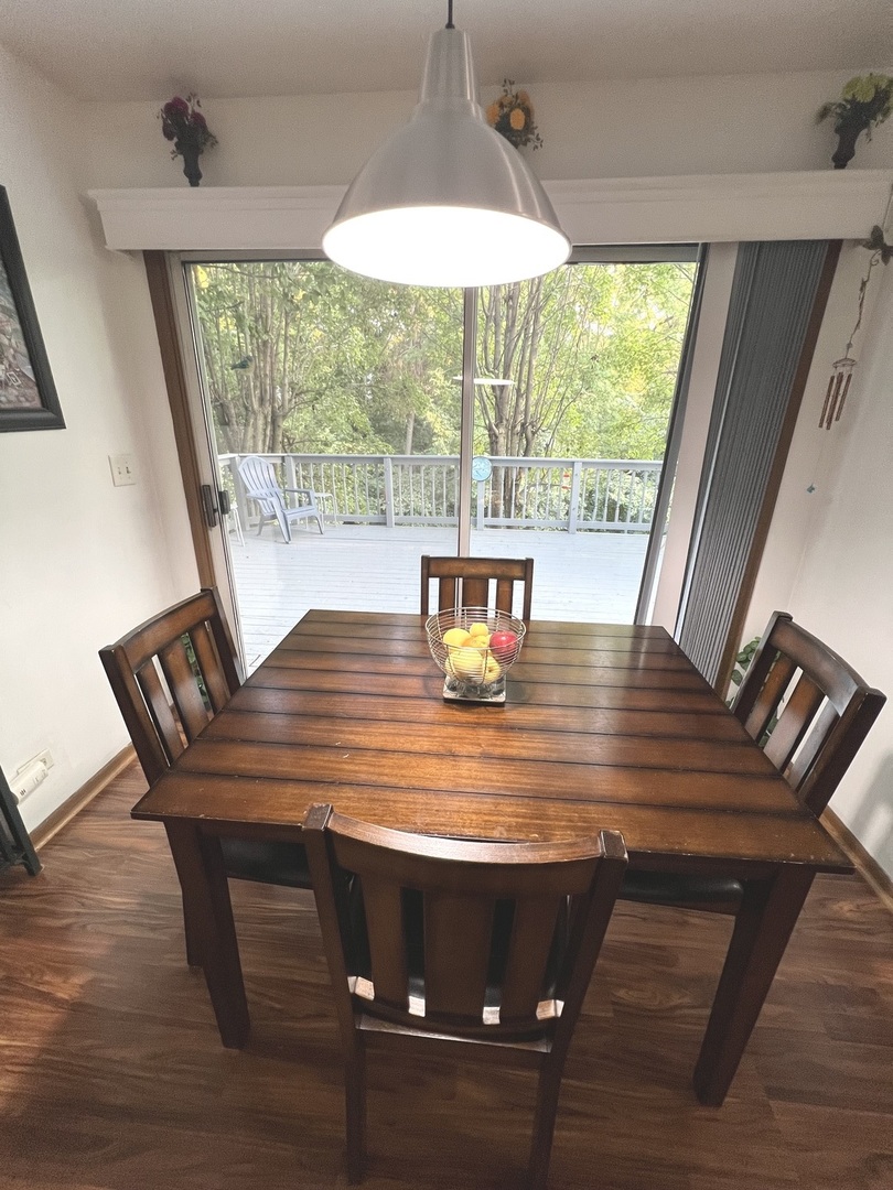 1018 Rain Tree Drive Bolingbrook, IL 60440 - Photo 8 of 22 a view of table and chair in wooden floor