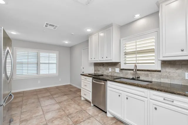 a kitchen with a sink stove and cabinets