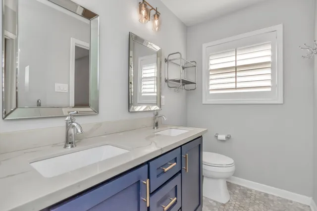 a bathroom with a sink toilet and mirror
